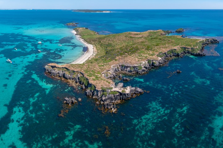 Aerial view of a small, rocky island surrounded by turquoise sea.